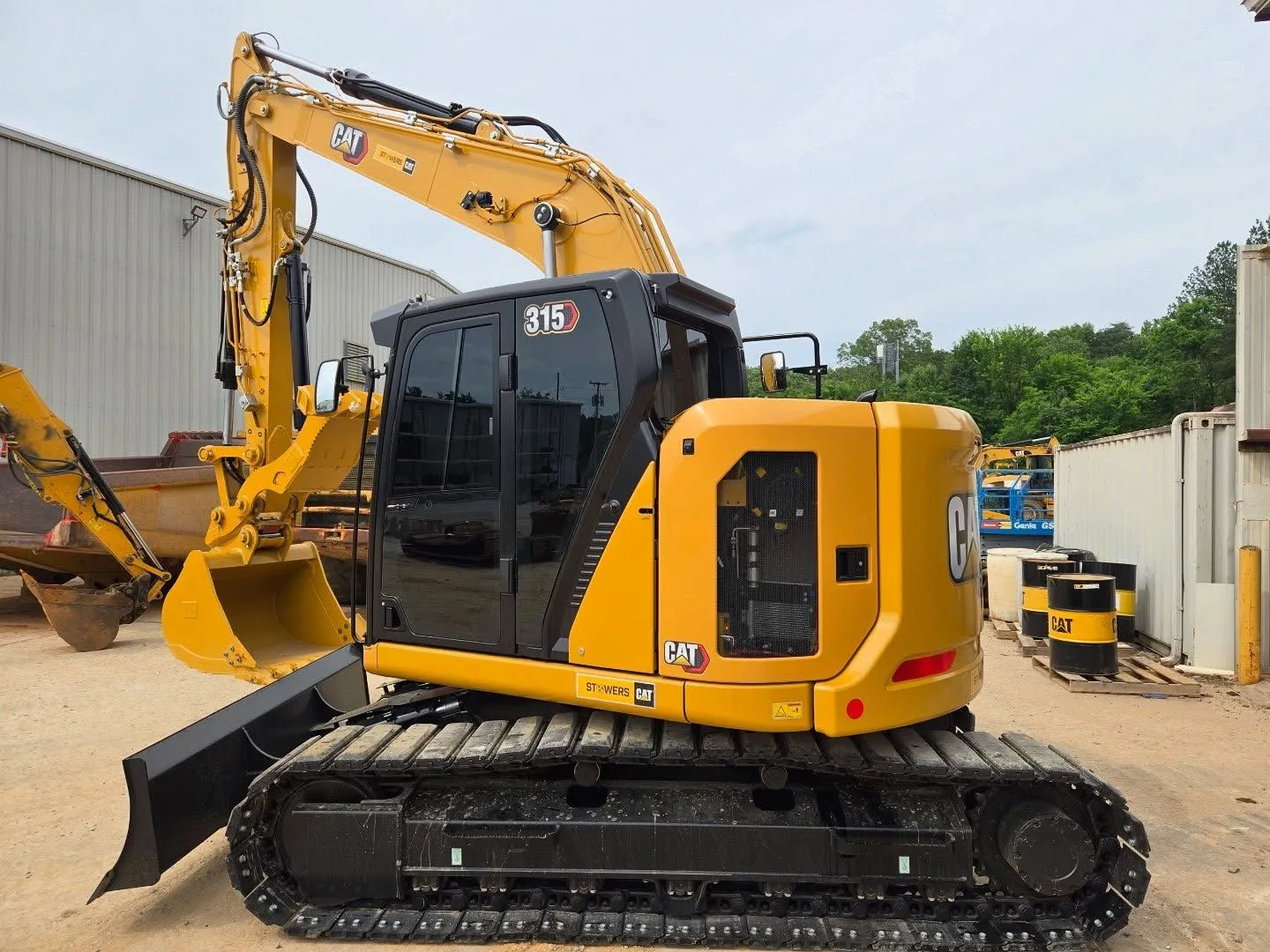 Yellow Caterpillar excavator on tracks.
